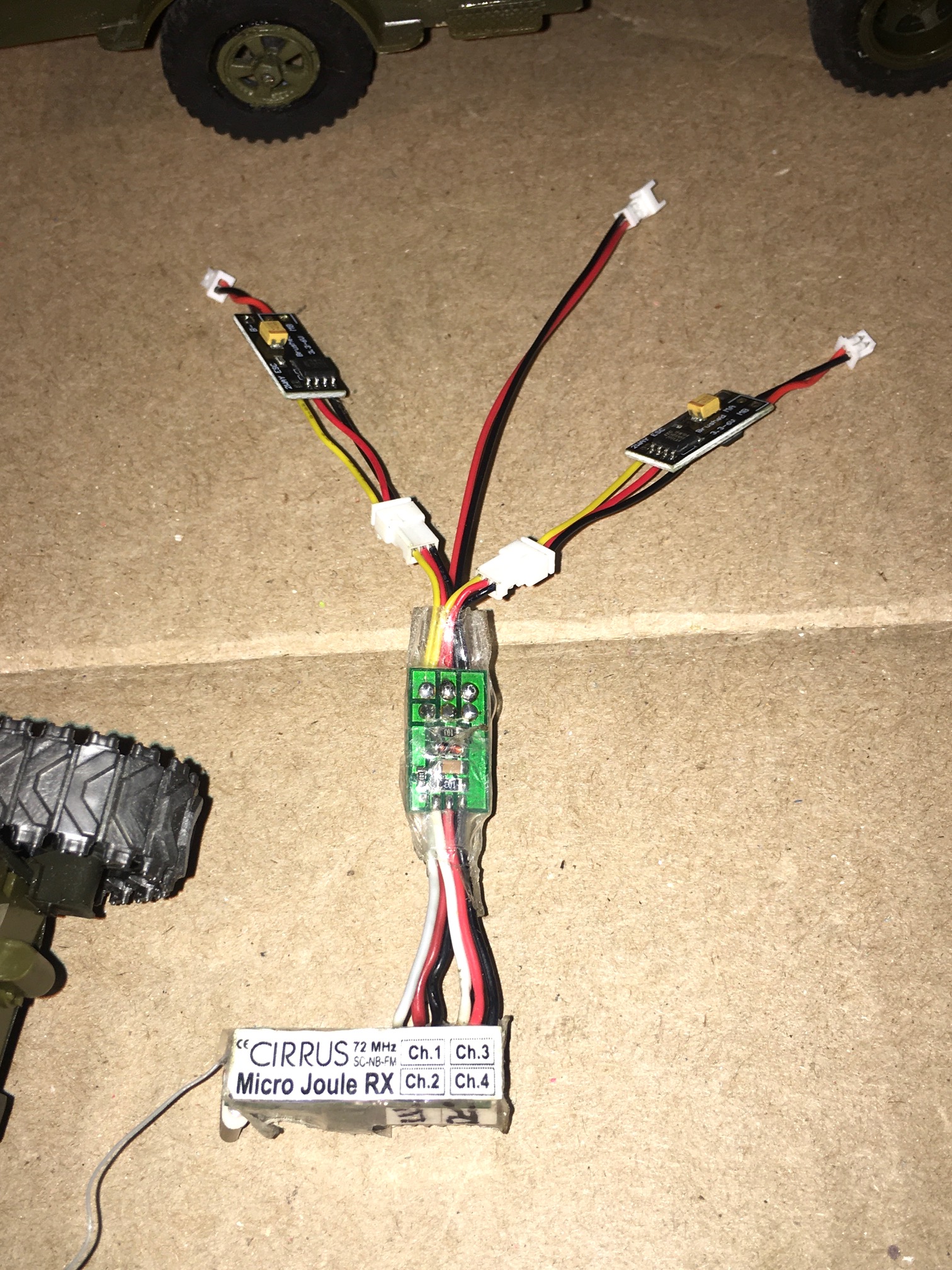 Here is the whole setup, 72mhz Micro Joule 4 channel Rx with Elevon mixer (throttle+Aileron input = Tank mix), two ESC's each driving a 4.3 ohm 130 motor. The wiring design includes a central located power source connector for even power distribution.