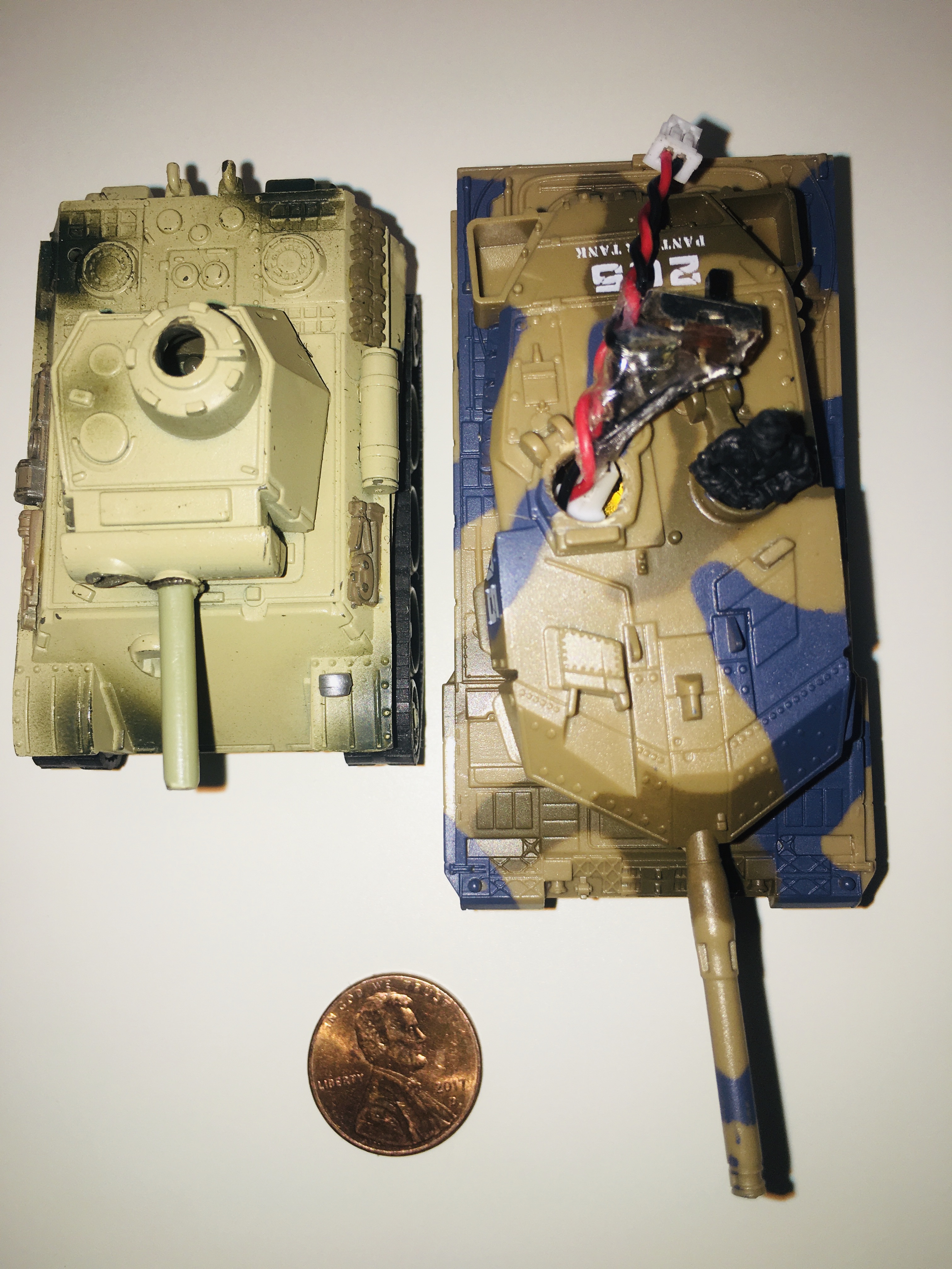 Both are 1:77 scale. I am switching to the Leopard II as it has superior ITL Tracks with sprocket teeth drive to the track. The plastic ITL track design requires less power to run than a low tech 1 piece rubber Track. The 100mAh lipo is mounted in the Leopard II Turret. A wiring harness with LVC added with on\off switch and lipo charging plug is now visible on the Leppard II Turret.