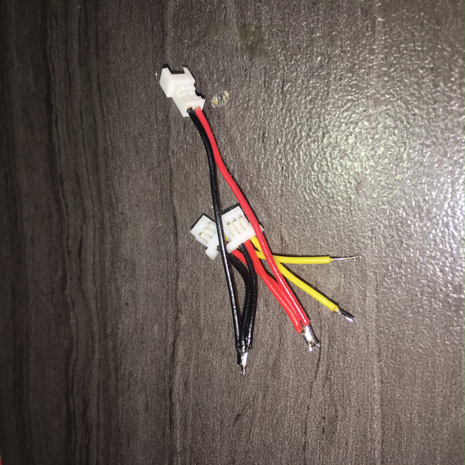 another view of a finished &quot;ESC input&quot; wiring harness. This Harness is for a RX with micro JST 1mm 3 wire channel output connectors. The 2 wire 1.25 mm micro JST connector is the 1s Lipo power in connector which powers the ESC directly through the 28 AWG black\red wires. The RX42 receiver is then powered through the channel connection red\black wires and does not use a seperate input power connection thus eliminating those RX power in wires. The yellow wires are the PPM signal wires for Aileron\elevator channels.