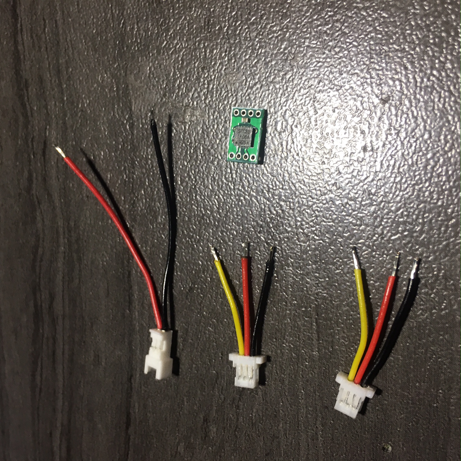 wires trimmed to length, ends striped of insulation, exposed wires solder tinned, and ready for red wires to be soldered together. This is the proper polarity shown in this picture. RED in the center for CROSSOVER-Servo ports: Micro JST-SH 1.00mm pitch. OTHERS MAY HAVE DIFFERENT POLARITY!