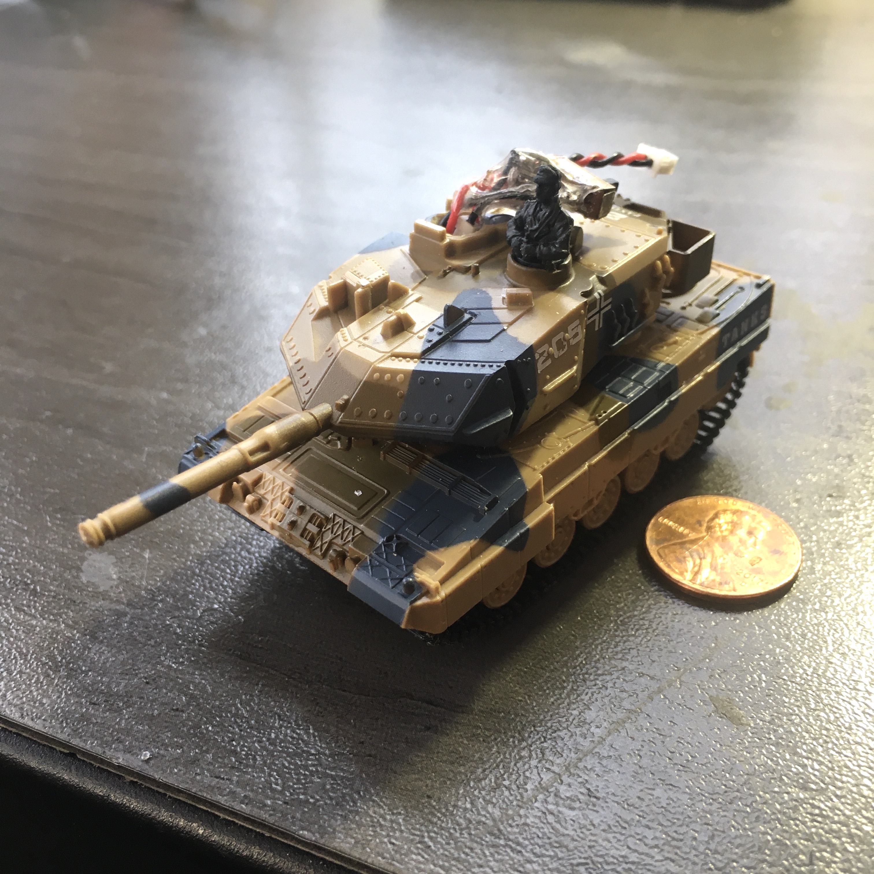 Here it is,  WORLDS SMALLEST (1:77) HOBBY GRADE RADIO CONTROL TANK.  A 100mAh lipo sits in the Turret. external on\off switch with charge plug is visible here.