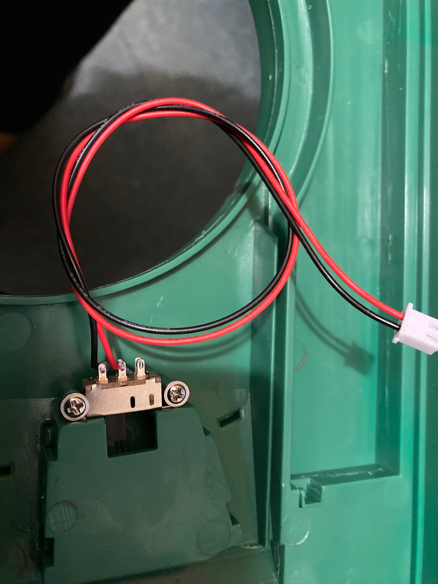 On/off switch held in place by two 2.6 x 6 flanged STS.