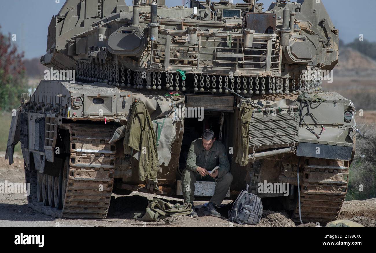 southern-israel-israel-23rd-nov-2023-an-israeli-soldier-sits-in-the-door-of-his-merkava-tank-and-reads-a-book-in-southern-israel-near-the-border-with-the-gaza-strip-on-november-23-2023-on-november-2.jpg