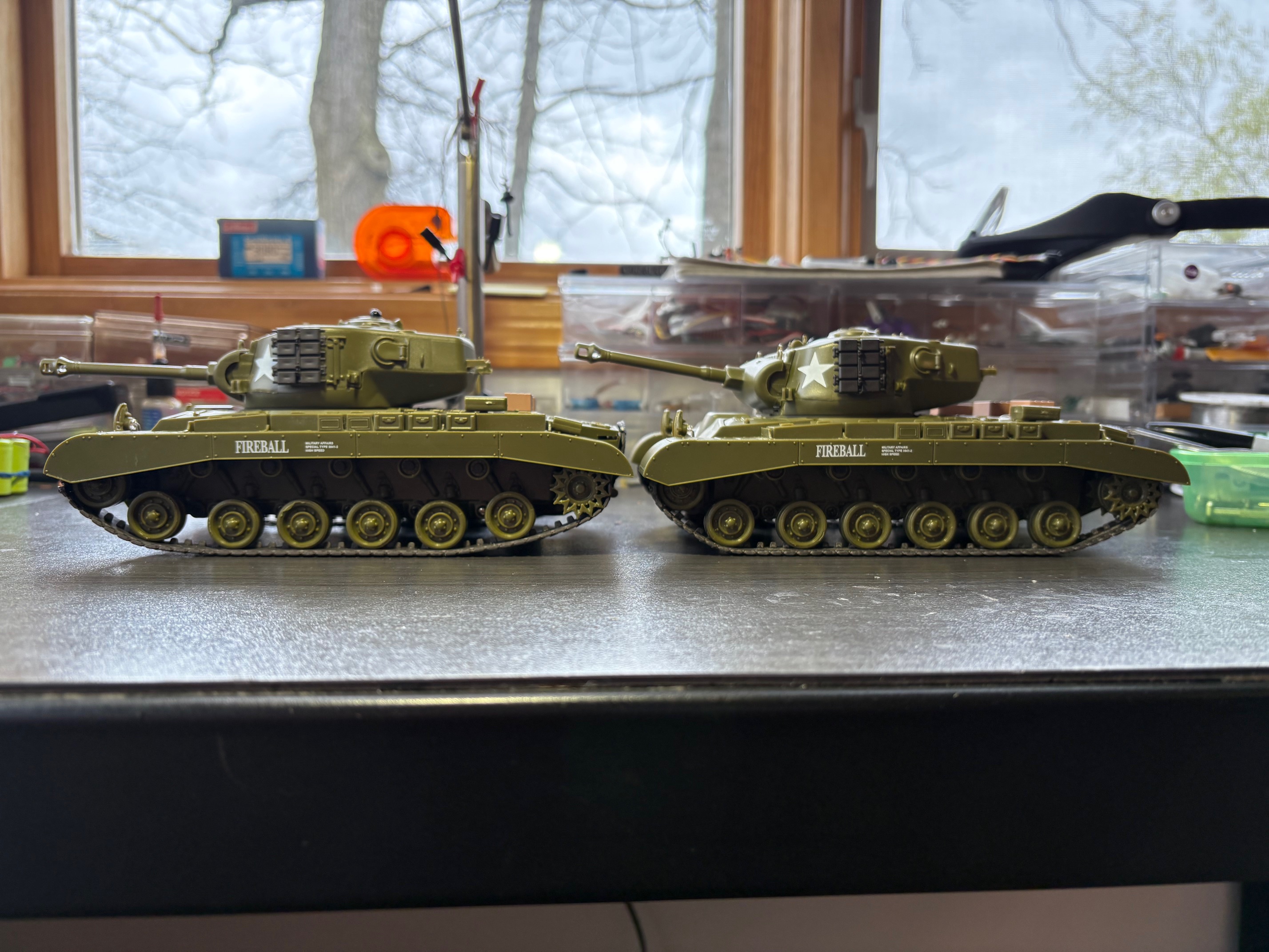 the tank in front has the suspension mod and now has four road wheels touching the ground at the same time  compared to 6. This is the only way to adjust the track tension and reduce turning resistance. Result of this mod is better turning and longer run time.