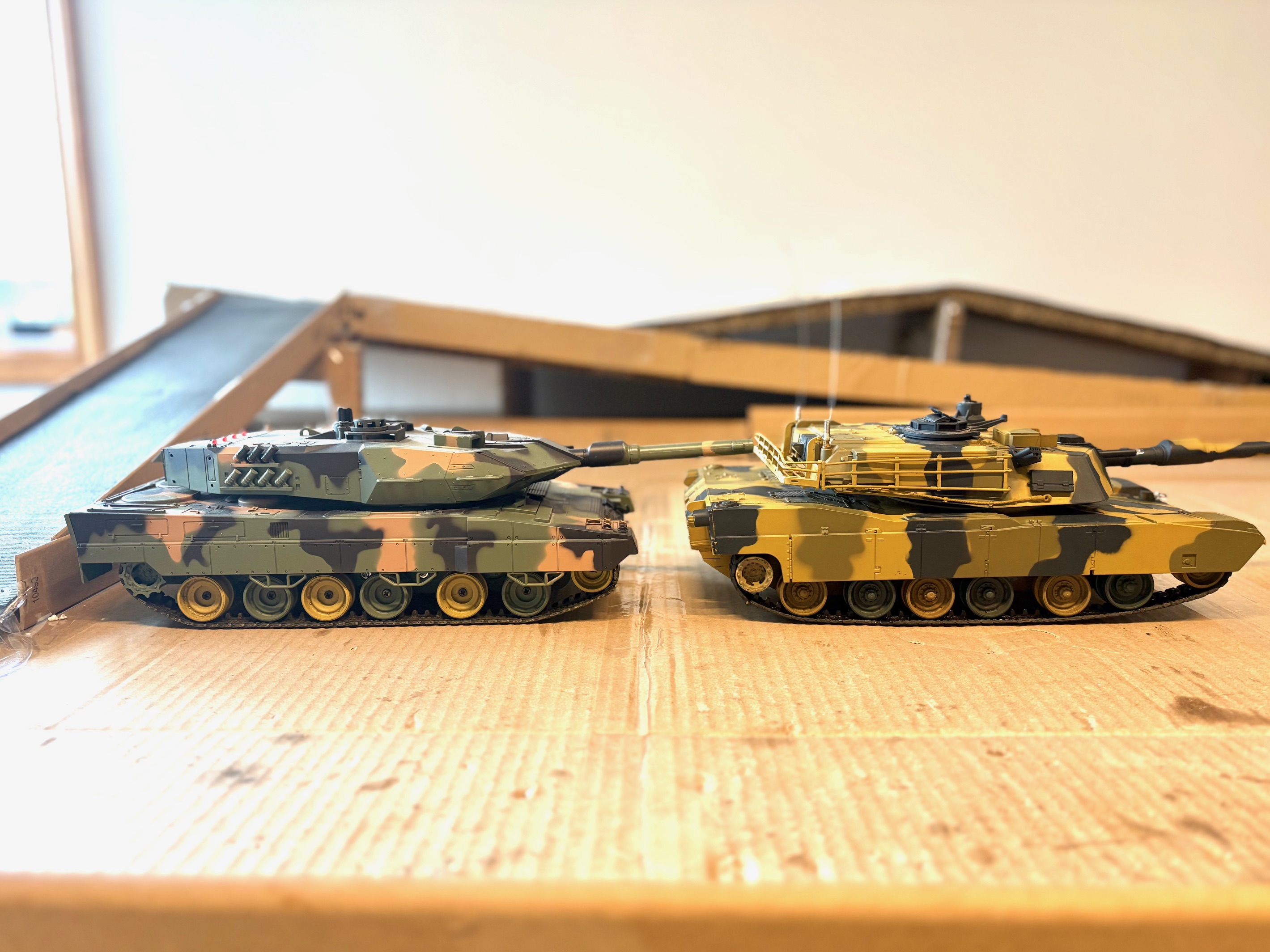 In this picture, you can see the difference in the road wheels. Leopard on the left is new and unmodified. M1 Abrams (2010) on the right has stock suspension. Note..the M1 came with a 8 cell nimh which would have made it balance more towards the rear. I seem to remember this Tank noticeably lifting the front when pushing the FWD button in high gear. (2 speeds FWD)