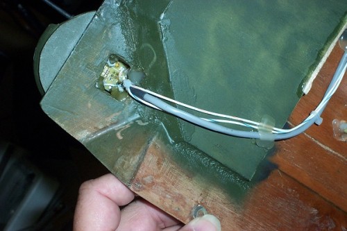 Bottom side. Hot glue works great.
