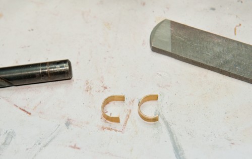Used some brass strips and use a drill bit to shape them.
