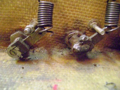 arm on left refitted with spring pin, on the right the original weld method