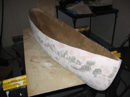 Hull nearly complete: a few more fiberglass layers and Bondo to fill some low spots..have to frame up the inside...  scribe cut line with indelible marker then trimmed with dremmel small rotary saw