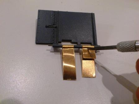 I used a pointed bit to crimp the metal strip around the clip.jpg