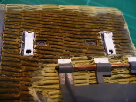Relocated in their correct position, the rear portion of the jack clamps with holes drilled to accept the securing rods.jpg