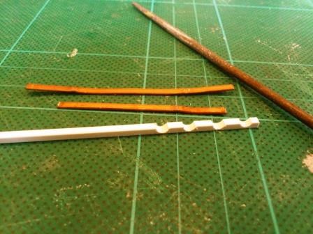 For the rear cable clamps I started by filing 4 U-shaped depressions in a piece of thick plastic square rod.jpg