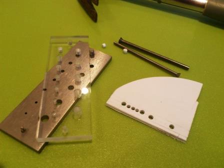 First I punched holes of the correct diameter - two big and three small - into a thick piece of plastic card.jpg