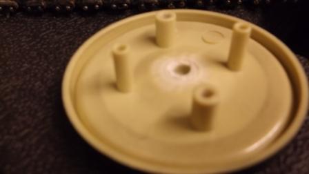 The road wheels come apart by removing 2 screws in the back of each one. (The idlers had to be junior hacksawed apart). The plastic spigot inside each wheel has to be removed to allow the fitting of the retaining 4mm star washers.
