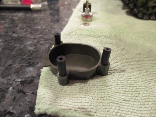 Cut to size and insert, not glue, rubber tubing  in the screw holes in the hatch insert.