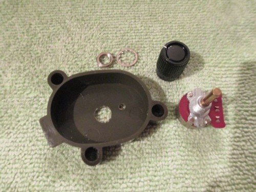 Drill a center hole to fit the threaded sound pot shaft and drill a smaller hole to the side for the placement stay to insert.