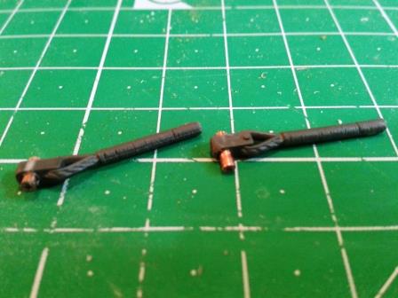 Both Tamiya track cable loops drilled out to accept brass rod.jpg