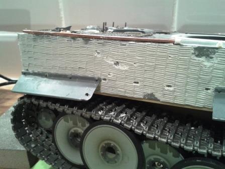 Here there is a gouge - perhaps from a deflected shot - to give some explanation for the lost side skirt.jpg