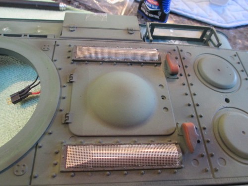 Tamiya mesh grill covers glued into place with little forming required.   They come with indents for the ribs on the Tamiya version and this also works on the HL or Taigen version.