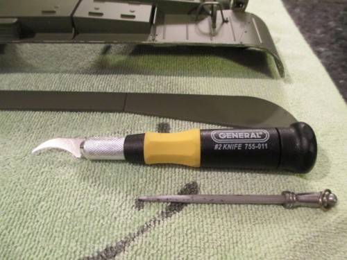 A close up of the tool and sharpener used to keep the blade edged.