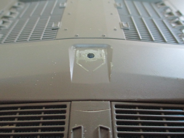 I used the Dremel with a small sanding tube and removed most of the cap and hinges.