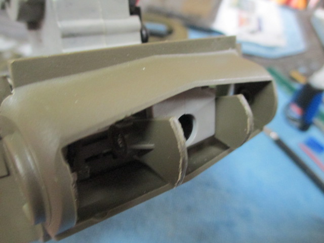 A scratch trunnion and mantlet mount made from a Tamiya cable mount.  Cut it in half and rounded the edges to fit the mantlet interior curvature.