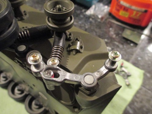 Metal suspension arms installed using the original push rivets and suspension springs.  New screw mounts replaced the original rivet on the connector.