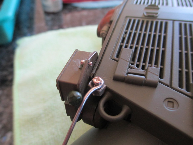 Before primer, drilled and added the tiny Tamiya bolt to the phone box to round out the use of the crimp bead.