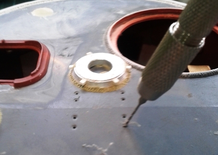 Drilling out the holes for the gun travel lock retaining bolts.jpg