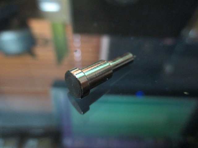 Remove this axle stud from the metal wheel assembly