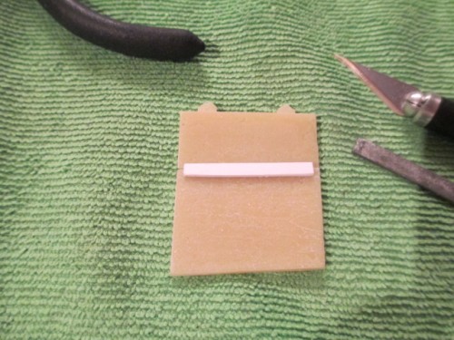 New hatch brace from styrene.  The brass piece was too thin and fragile.
