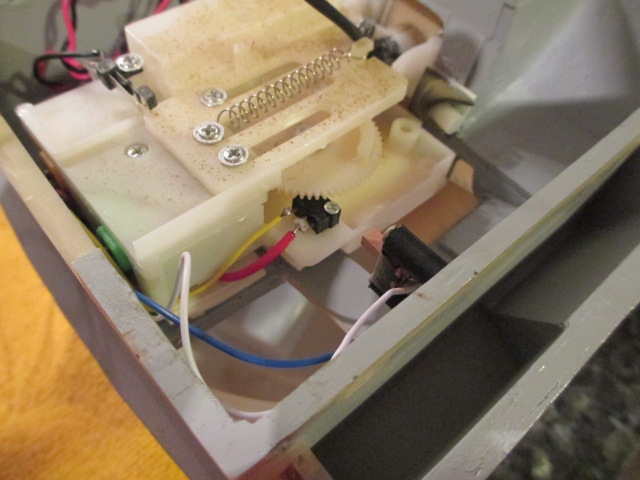 Gun On-Off switch remounted using rubber tubing and screws.