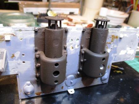 The exhaust and the part of the rear plate behind the exhaust shields now primed with a darker colour.jpg