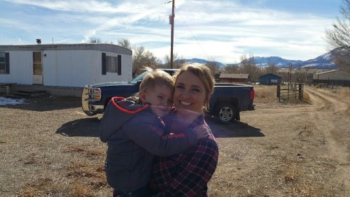 Agent and her progeny with the old mobile home we are fixing up as an office, behind her.