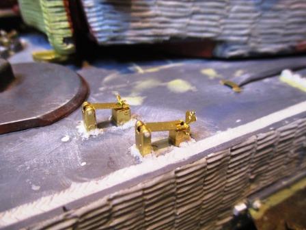 The front cable clamps from Voyager after bedding in with Magic Sculp weld beads.jpg