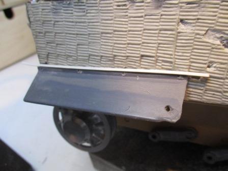 A plastic strip was firmly glue along the top of each track guard.jpg