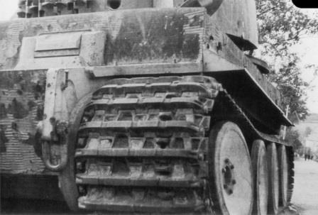 Unusual low viewpoint shot showing thickness of hull above the sprocket and attachment hook for front fender. Also of note - this Tiger has early tracks (no chevron ice cleats) and no central headlight.jpg