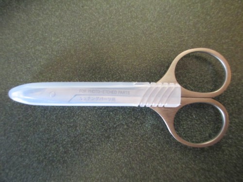 Tamiya PE scissors.  No more dulling my Exacto blades one after another.