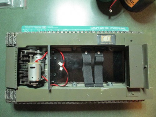 Electronics bed mounted with velcro squares for easy removal.  Watch the placement of this as the upright can interfere with the turret rotation gear if too far back.
