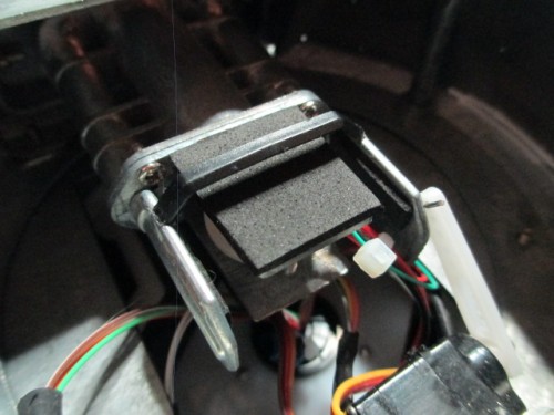 Gun breech somewhat simulated by a flexible rubber piece with an added crossbar and rubber blocks on the sides.  The top is flexible to access the servo screw adjustment.