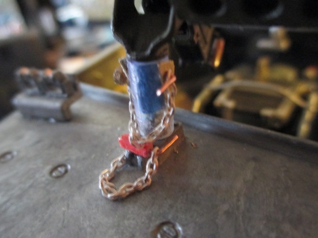 The base is designed to lay flat on this mount so adding another  pin and chain seemed obvious.  The base set is decorative  tho' the handlepin can be pulled out to lay loose