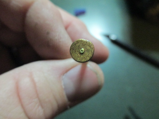 Beginning with the nails required a tiny brass washer to give them a primer circle.  After that was a coat of brass paint that is curing overnight.