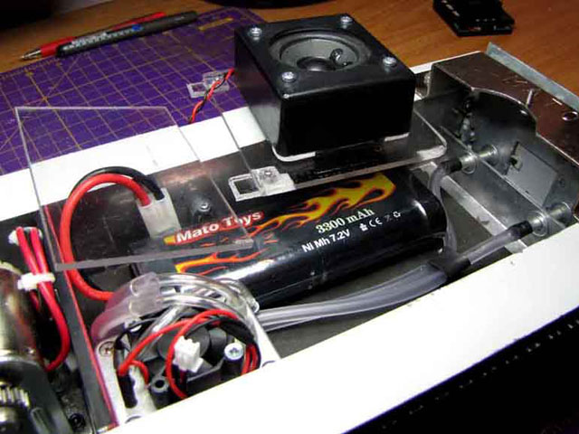 With this upper deck fitted the floor area is increased around 70%. The battery is easily removable and indeed the space allocated will accommodate a larger battery if required (I doubt it). There is also additional space now available beside the smoker plumbing for electonics, accessories, etc. The next step is to fix the other components in place, starting with the speaker