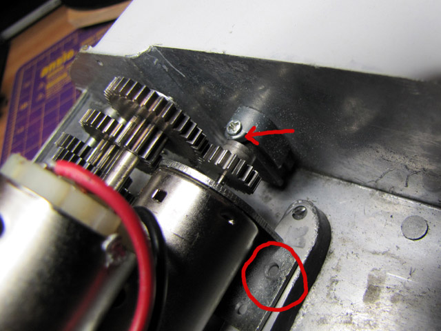 The bogies are held in place on the inner side of the hull by a horseshoe shaped wedge that pulls the bogies tight into the hull. On top (see pic) there is hole in the horseshoe wedge and one corresponding in the part of the bogies that protrudes into the hull and which the wedge slots down on. This hole is intended for a self tapping screw hold the horseshoe clip down and in place. Mato left all the screws off of my M36 which I thought was strange. This now explains the Mato glue monster, Mato had glued all the horseshoe clips, and the bogies themselves, to the hull because they were leaving off the retaining screws. The question is why? Anyway, I managed to replace them all. However, the clip/wedge on the right of the picture - the part at the top where the screw goes through is missing, as is part of bogie block that protrudes through the hull. This has actually been ground away by Mato but again, I wondered, why? I soon found out as can be seen in the next picture. When I went to replace the gearboxes I found the the front most bogie retaining wedge fouled the motor pinion gear sufficiently to move the gearboxes off their bolt hole centers - this is why Mato ground down the front bogies and retaining wedges, and why they thought they needed to dispense with the screws (and get their glue monster on the job). I had inadvertently placed the ground down bogies at the rear instead of the front.