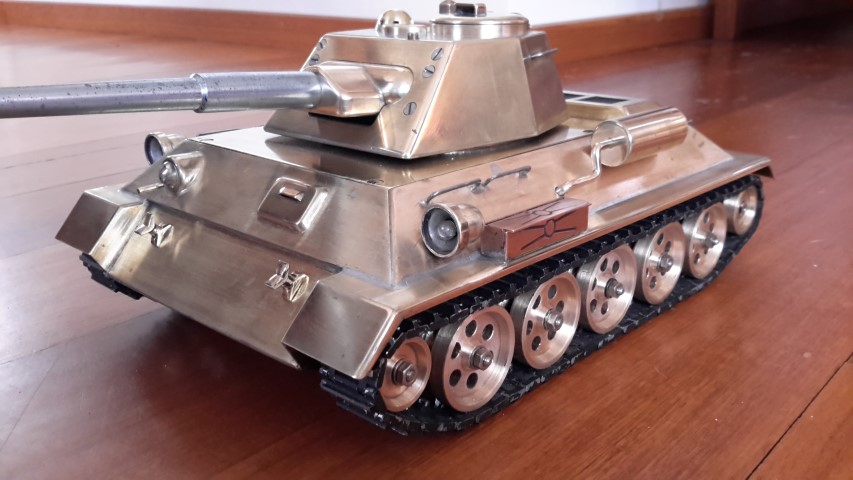 Build this T-34 tank in 1965 from a East German hobby magazine that was published in the early fifties. The tank is totally made from brass and soft soldered together it weighs 8.5 Kg. Each track has 62 links and is made from steel. The gun fires 4.5mm caliber bullets.