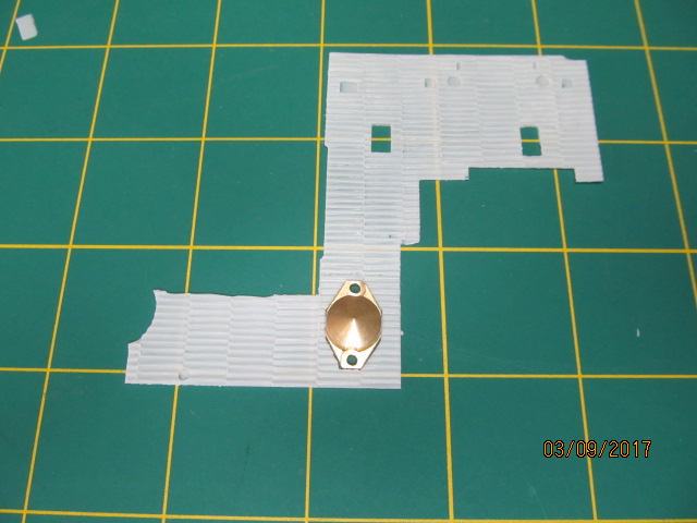Trimming zimmerit sheet around idler adjustment cover.