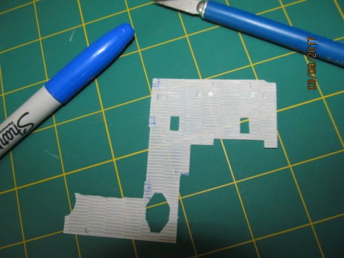 Marking cut out areas for exhaust shrouds.