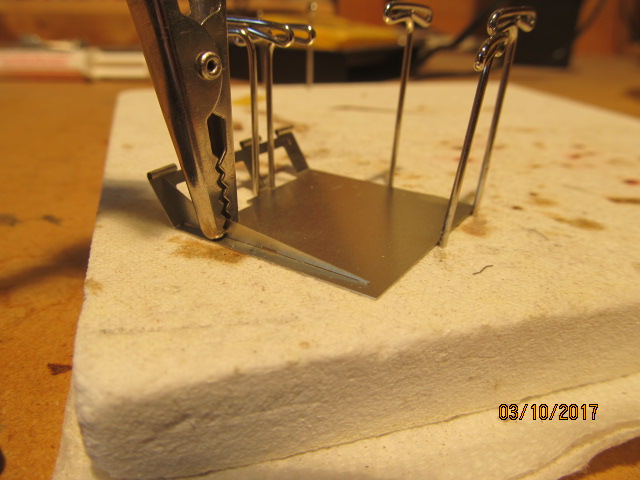 Soldering rear fender support fins in place.