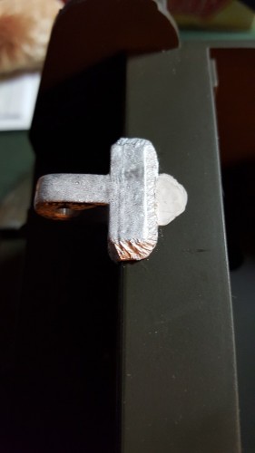 Closeup of putty cut and sanded down.  This fills the screw holes which held the cover closed.