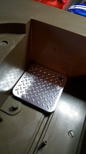 A metal cover off of a gift card box is drilled and screwed into place using the speaker mounting posts.  It is a nice cover for the original speaker grill.